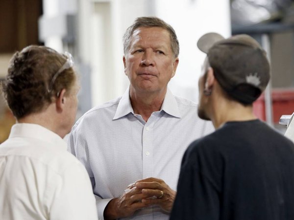 Ohio Gov. John Kasich talks with Joshua Bowman right and Joe Shean during a visit at RP Abrasives in Rochester N.H. Kasich is declaring his candidacy for the 2016 Republican presidential nomination on July 21