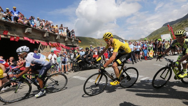 Colombia's Nairo Quintana and Britain's Chris Froome wearing the overall leader's yellow jersey climb Glandon pass during the eighteenth stage of the Tour de France