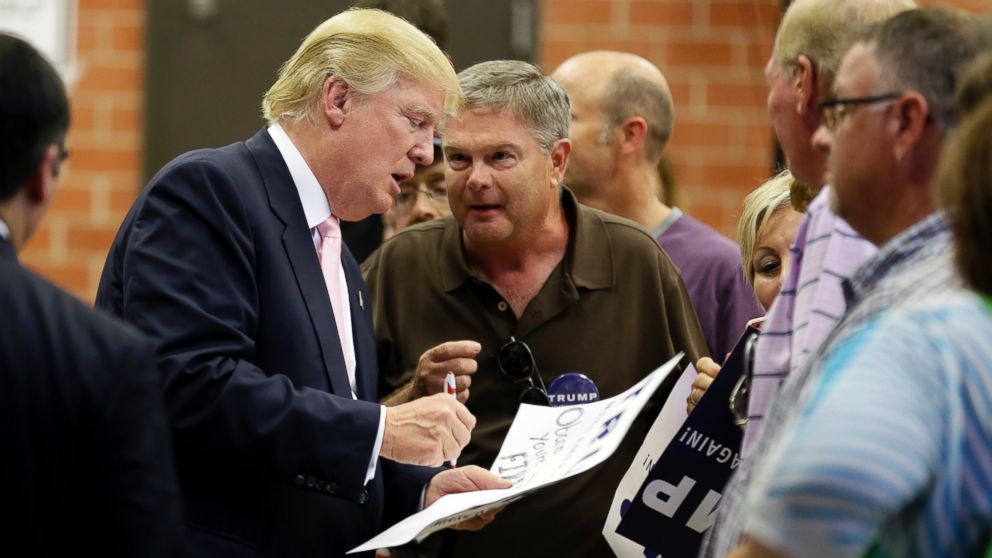 Donald Trump signs autographs after speaking at a rally and picnic Saturday