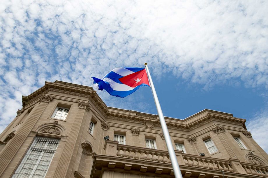 Cuba's blue red and white-starred flag was hoisted Monday at the country's embassy in Washington in a symbolic move signaling the start of a new post Cold War era in U