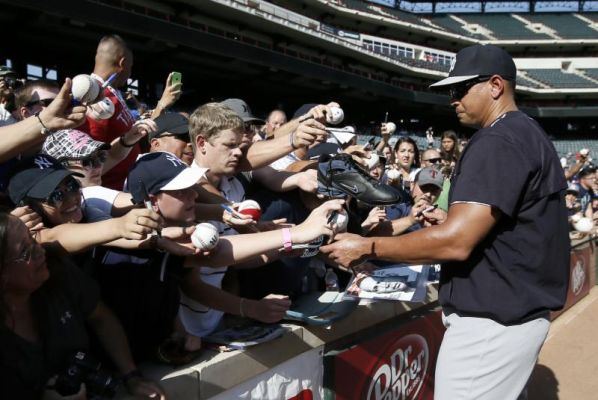 New York Yankees Alex Rodriguez signs autographs for