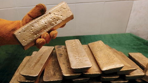 A melter places an ingot of 92.96 percent pure gold at a procession plant of the Olimpiada gold operation owned by Polyus Gold International company in Krasnoyarsk region Eastern Siberia Russia