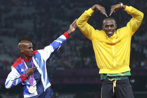 Usain Bolt celebrates with Britain’s Mo Farah