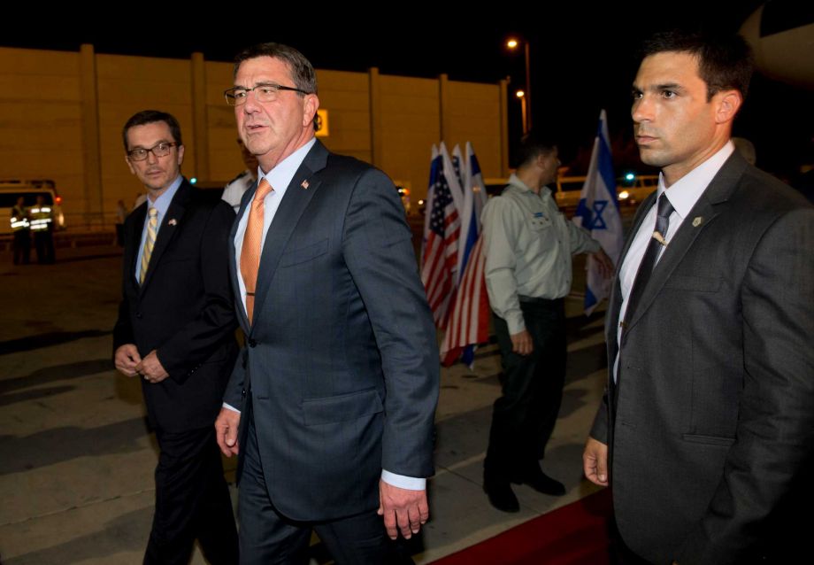 U.S. Defense Secretary Ash Carter walks with William Grant U.S. Embassy Deputy Chief of Mission left and members of his security detail as he arrives at Ben Gurion International Airport in Tel Aviv Israel Sunday