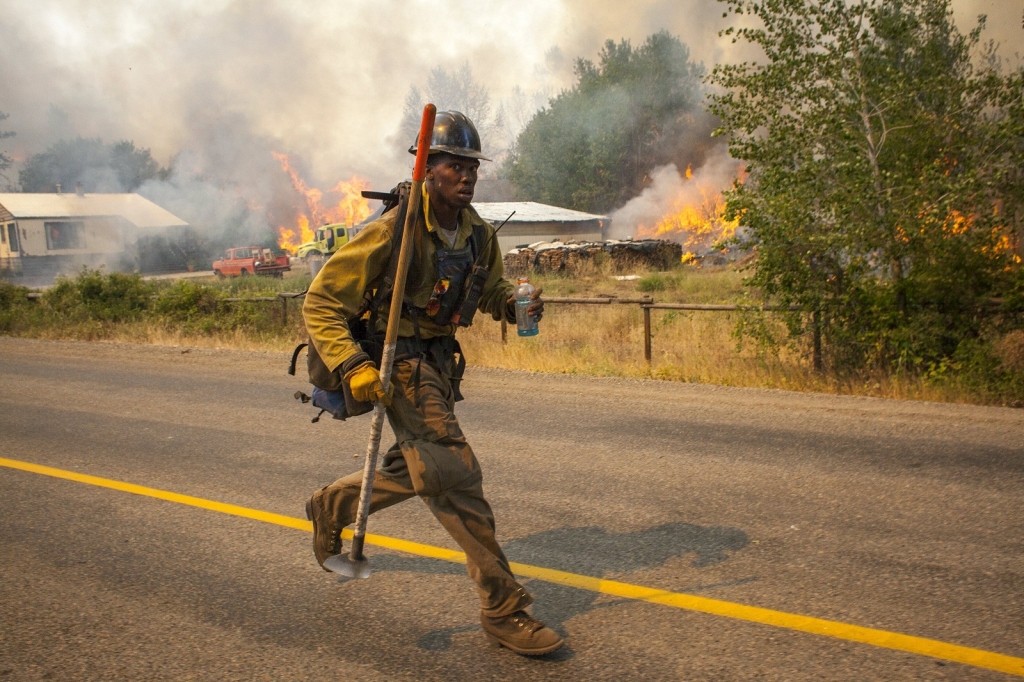 A firefighters flees as the Twisp River fire advances unexpectedly near Twisp Washingt