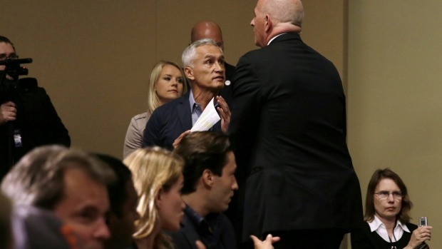 A security guard for Republican presidential candidate Donald Trump removes Miami-based Univision anchor Jorge Ramos from a news conference