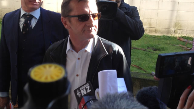 Phil Rudd appears outside court this morning