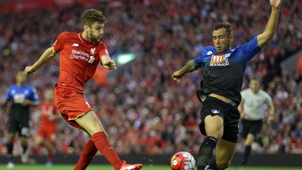 Liverpool's Adam Lallana left fires in a shot on goal during their English Premier League soccer match against Bournemouth at Anfield in Liverpool England Monday Aug. 17 2015. | AP