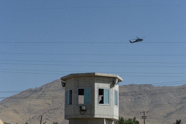 A UH-60 Black Hawk helicopter flies over the site of a suicide attack in a compound in Kabul