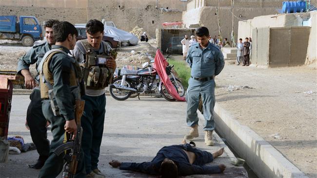 Afghan security personnel inspect the body of a Taliban militant after an attack in Kandahar Afghanistan