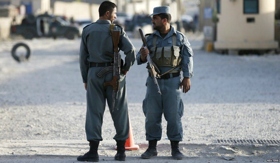 Afghan policemen keep watch at the site of an attack outside a base in Kabul Afghanistan- 8 August 2015