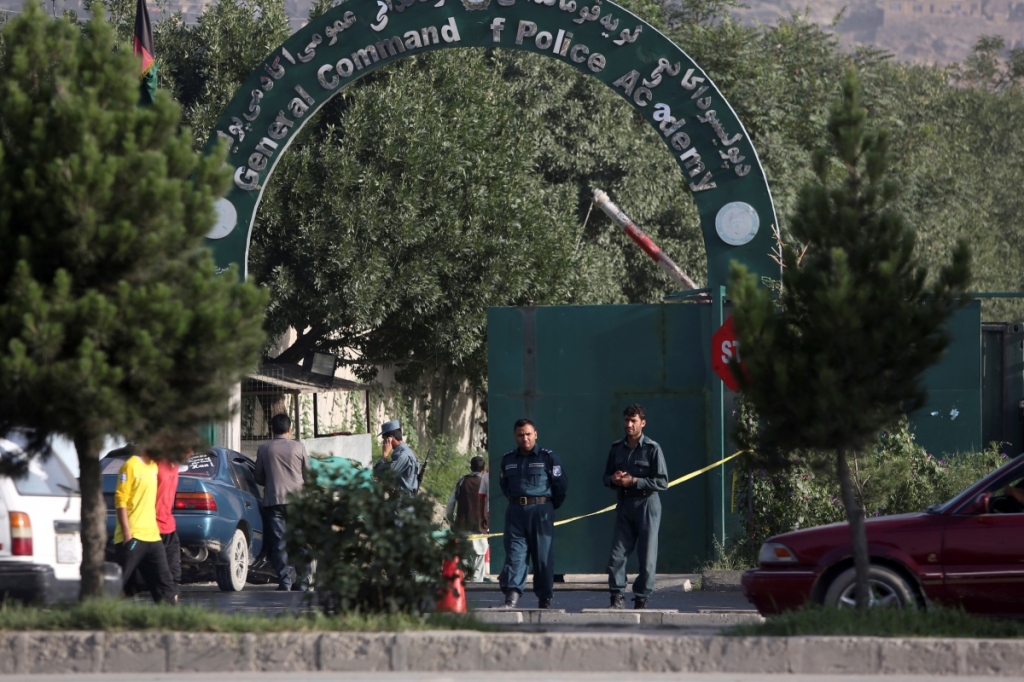 Afghanistan's national police stand guard at the entrance gate of Police Academy a day after two massive attacks in Kabul Afghanistan