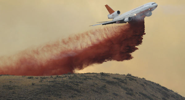 An air tanker drops red fire retardant on a wildfire near Twisp Washington today. Pic AP