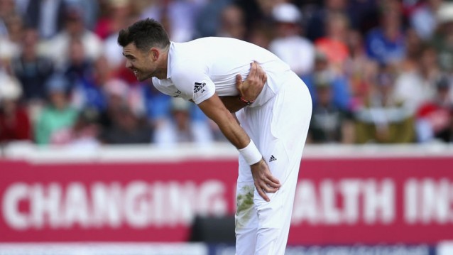 James Anderson Holds his side after injury