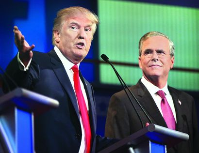 Donald Trump speaks as Jeb Bush listens during the first Republican presidential debate Thursday in Cleveland