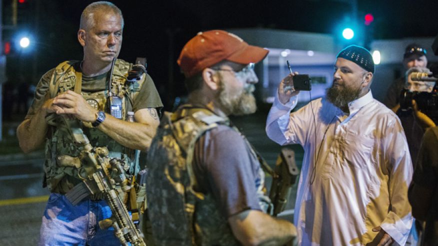 Aug. 11 Members of the Oath Keepers walk with their personal weapons on the street during protests in Ferguson