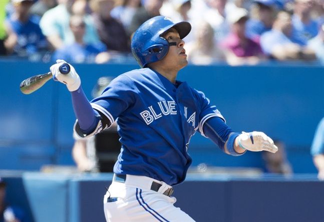 Toronto Blue Jays Ryan Goins hits a three-run home run during second inning MLB baseball action against the Oakland Athletics in Toronto on Thursday