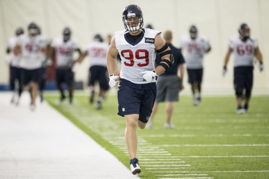 Houston Texans defensive end J.J. Watt runs across the practice field during Texans training camp at the Methodist Training Center Monday Aug. 24 2015 in Houston