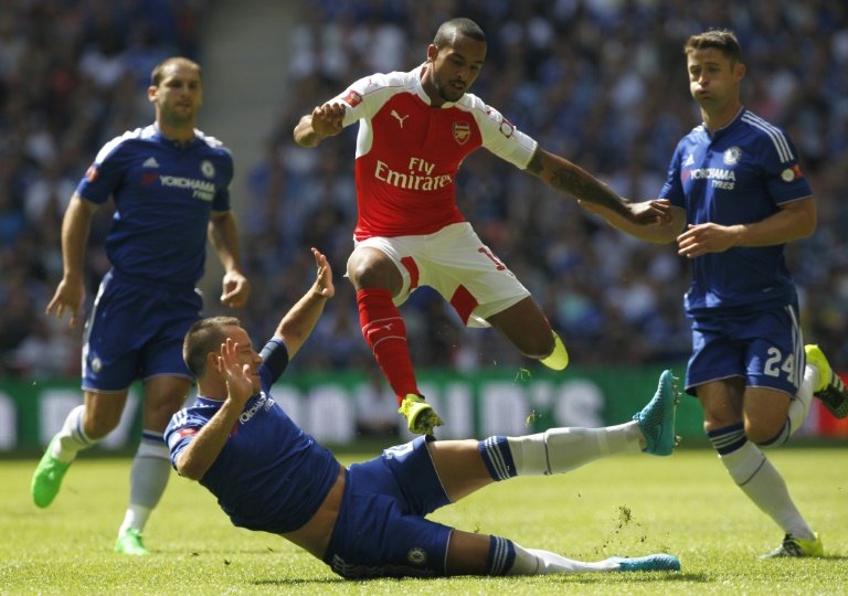 Arsenal's English midfielder Theo Walcott evades the challenge from Chelsea's English defender John Terry during the FA Community Shield football match between Arsenal and Chelsea at Wembley Stadium in north London