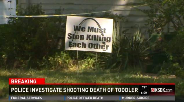 A sign lamented gun violence outside the St. Louis County house where police say a toddler accidentally shot himself with a handgun on Tuesday afternoon