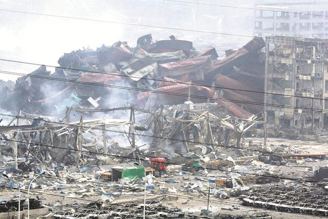 Deformed containers pile up at the site of an explosion at a warehouse in northeastern China’s Tianjin municipality Friday