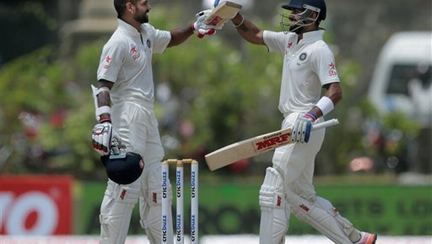 India's Shikar Dhawan left celebrates scoring a century with teammate Virat Kohli during the second day of their first test cricket match against Sri Lanka in Galle Sri Lanka. |AP