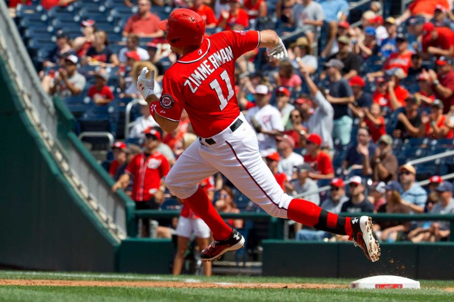 Washington Nationals Ryan Zimmerman rounds first base after hitting an RBI double during the first inning of a baseball game against the Milwaukee Brewers at Nationals Park in Washington