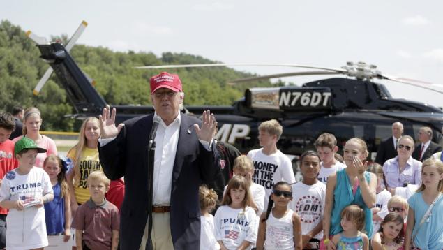 Republican presidential candidate Donald Trump speaks before treating some area kids and their parents to a helicopter ride in his $7 million aircraft