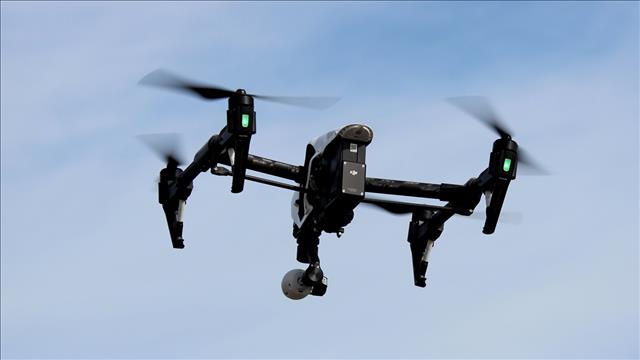 Officials say a drone has dropped a package of drugs into an Ohio prison yard while inmates were outside sparking a fight