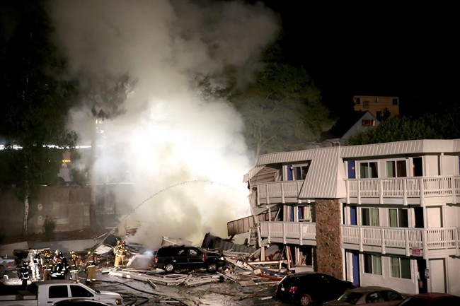 Firefighters cool down hot spots after an explosion at a Motel 6 Tuesday Aug. 18 2015 in Bremerton Wash. The explosion occurred just minutes after the acting hotel manager evacuated the building due to reports of a gas leak. (Larry Steagall  Kitsap Su