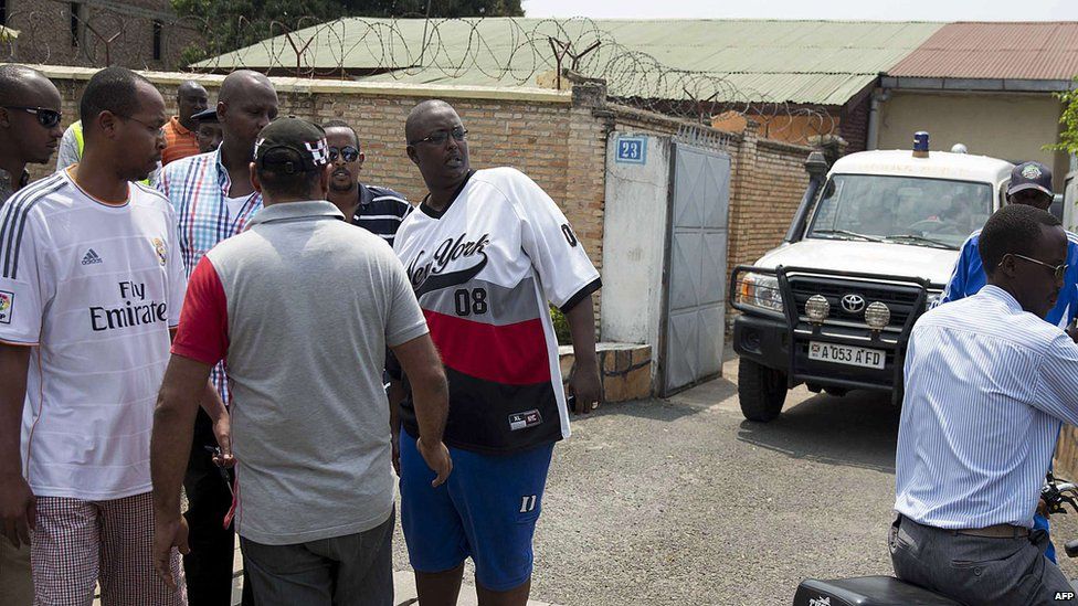 Relatives of Colonel Jean Bikomagu stand outside his home on 15 August 2015