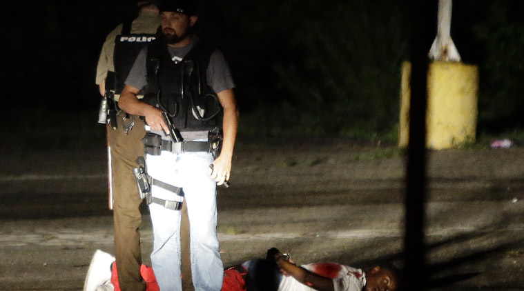 Members of the Oath Keepers walk with their personal weapons on the street during protests in Ferguson Missouri