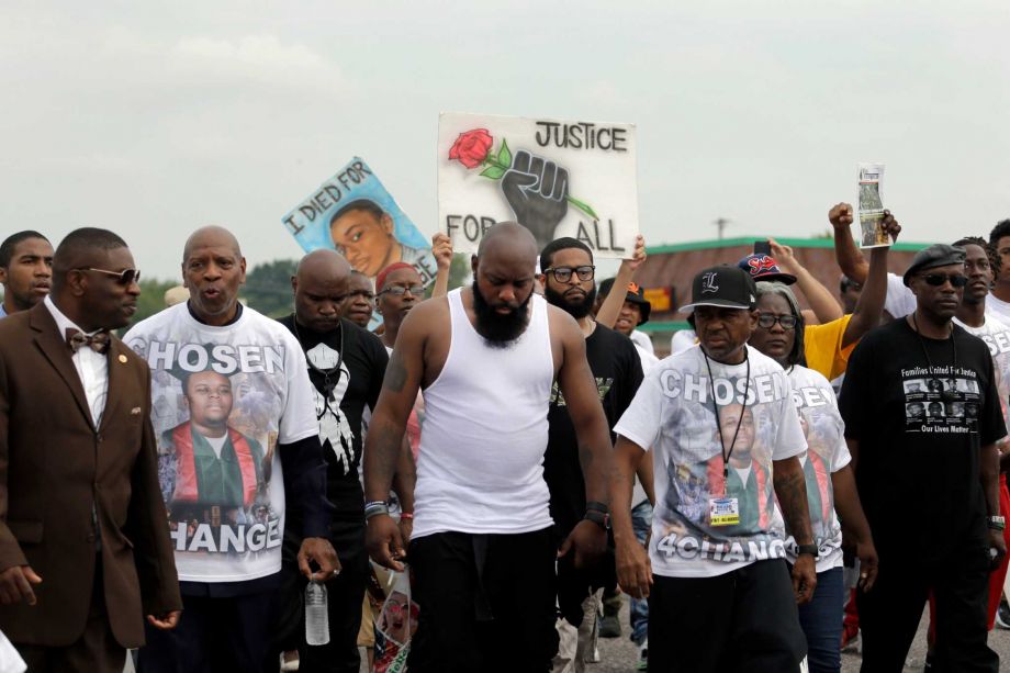 Michael Brown Sr. center takes part in a parade in honor of his son Michael Brown Saturday Aug. 8 2015 in Ferguson Mo. Sunday will mark one year since Michael Brown was shot and killed by Ferguson police officer Darren Wilson