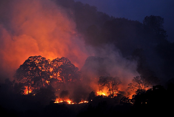 Trees and brush burn as firefighters light backfires while battling the Wragg fire nears Winters California