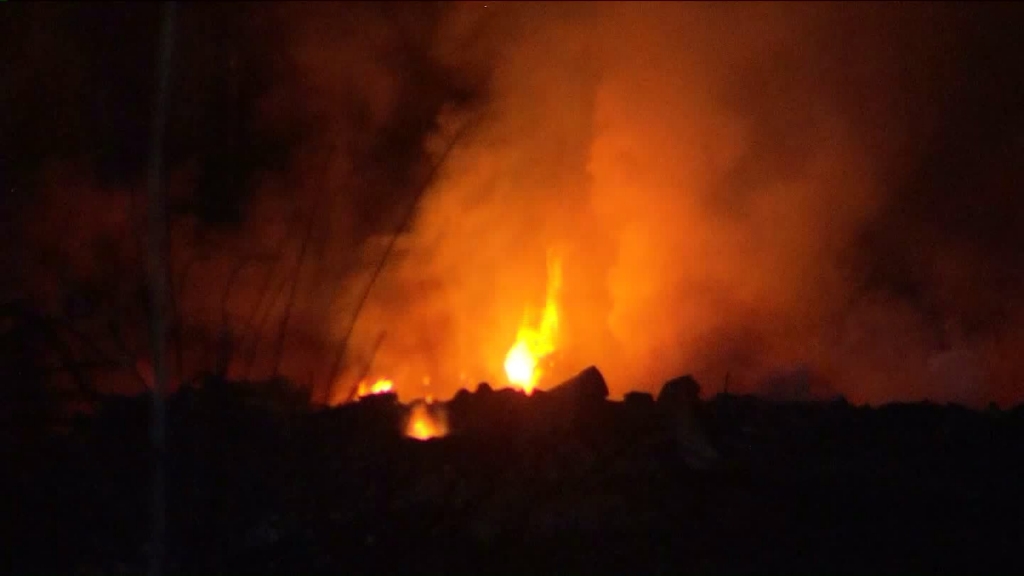 Flames are seen in a Montebello riverbed on Monday Aug. 17 2015