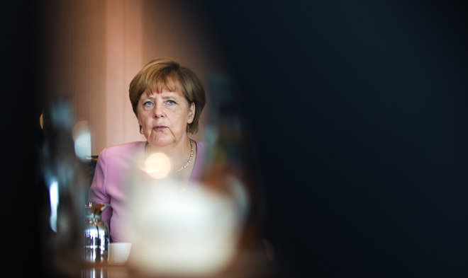 German chancellor Angela Merkel waits for the beginning of her first cabinet meeting after her summer holidays in the Chancellery in Berlin Germany Wednesday Aug. 12 2015