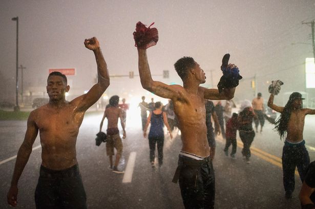 Demonstrators marking the one-year anniversary of the shooting of Michael Brown