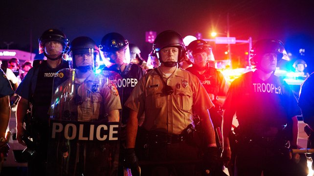 Gunfire erupted during a standoff between police in riot gear and protesters