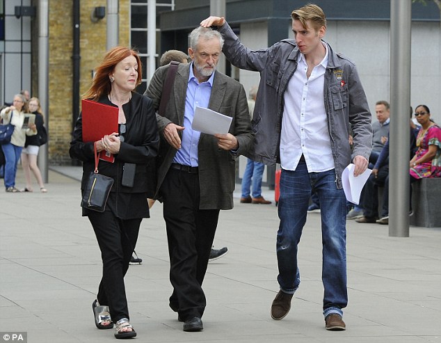 Hair apparent The Labour front-runner gets a helping hand from son Seb on the way to a political rally yesterday