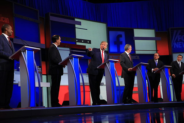 Donald Trump the real estate mogul and television personality points to a rival during the first Republican presidential primary debate at the Quicken Loans Arena in Cleveland Aug. 6 2015. From left Ben Carson Gov. Scott Walker of Wisconsin Trump