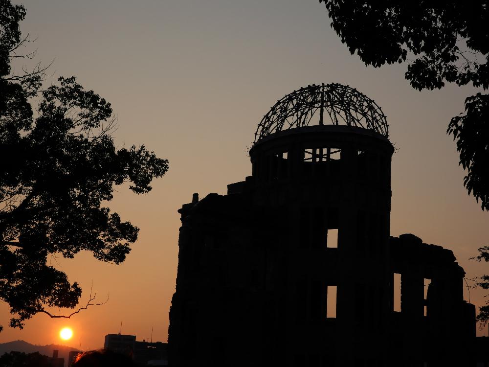 The sun sets behind the Atomic Bomb Dome at the Hiroshima Peace Memorial Park on the day before the 70th anniversary of the atomic bombing of Hiroshima