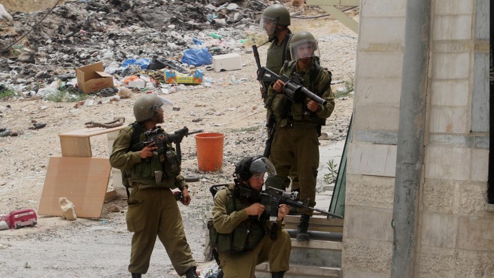 IDF soldiers stand guard during a protest at the Qalandia checkpoint near the West Bank city of Ramallah