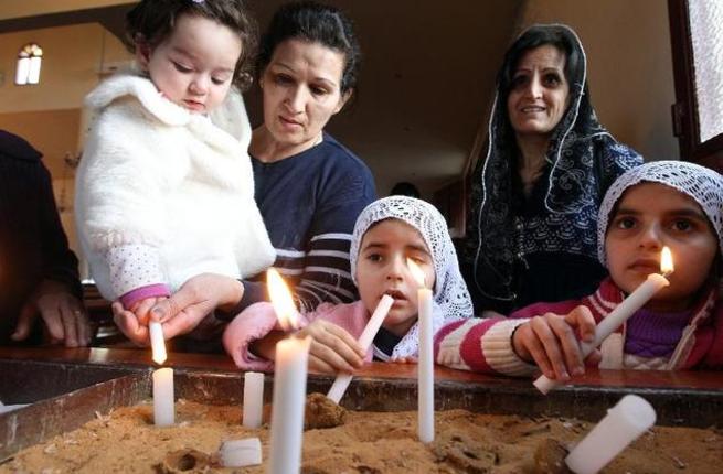 Assyrian Christian women and their daughters who fled from Syria attend a prayer for the 220 Assyrian Christians abducted by Islamic State group jihadists in Syria at the Saint Georges Assyrian Church in Jdeideh Lebanon