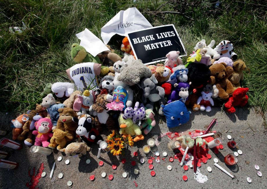 Stuffed animals and candles are arranged at a memorial for 15-year-old Andre Green Tuesday Aug. 11 2015 in Indianapolis. The leader of a faith-based anti-crime group said Tuesday that the Indianapolis police department needs to equip all of its office