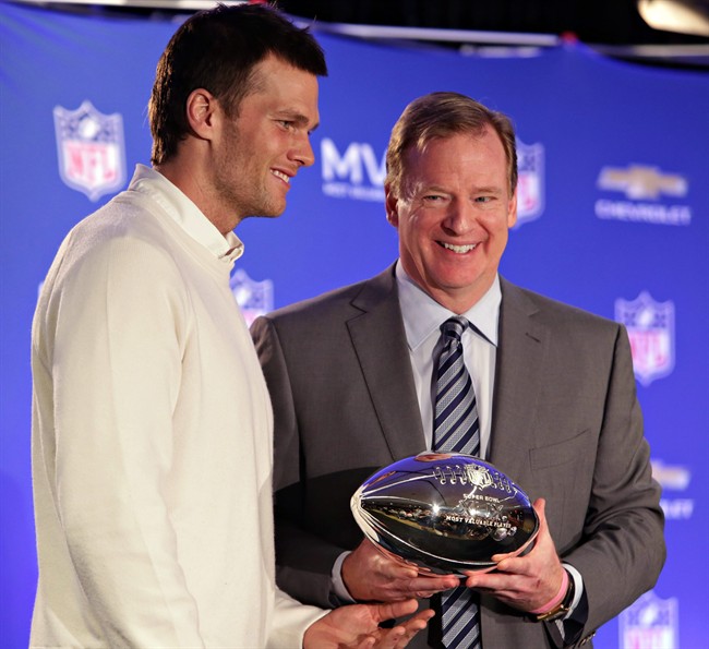 New England Patriots quarterback Tom Brady left poses with NFL Commissioner Rodger Goodell during a news conference where Brady was presented the Super Bowl MVP in Phoenix Ariz. Brady's four-game suspension