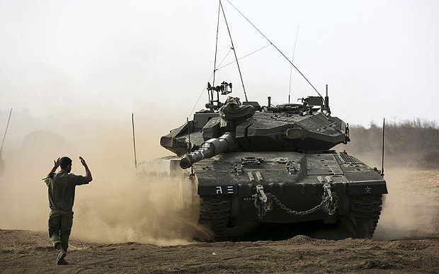 An Israeli soldier directs a tank during an exercise in the Israelioccupied Golan Heights near the ceasefire line between Israel and Syria