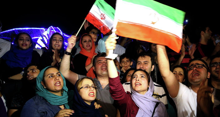 Jubilant Iranians sing and wave Iran flags during street celebrations following a landmark nuclear deal in Tehran Iran Tuesday