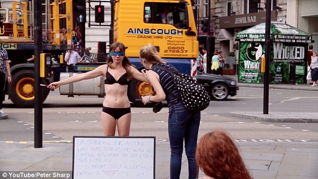 Jae West took to Piccadilly Circus wearing nothing put her underwear to promote self-acceptance