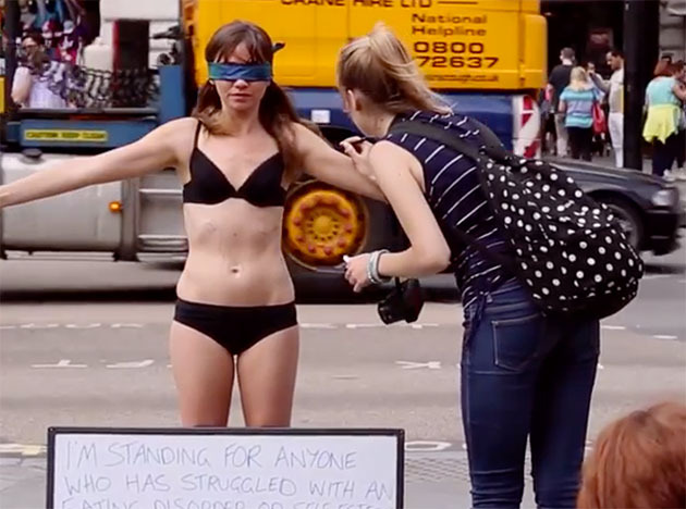 Jae West undressed in London's bustling Piccadilly Circus to urge women to love their bodies