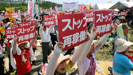 Anti-nuclear protesters holding a rally against the restart of a nuclear reactor in front of the Kyushu Electric Power Sendai nuclear power plant